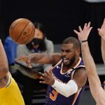 Phoenix Suns guard Chris Paul, center, passes the ball as Los Angeles Lakers forward Jared Dudley, left, and guard Alex Caruso defend during the first half of an NBA basketball game Tuesday, March 2, 2021, in Los Angeles. (AP Photo/Mark J. Terrill)