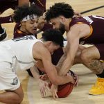 Arizona State's Alonzo Verge Jr., from left, Oregon's Will Richardson (0) and Arizona State's Holland Woods (0) scramble for the ball during the first half of an NCAA college basketball game in the quarterfinal round of the Pac-12 men's tournament Thursday, March 11, 2021, in Las Vegas. (AP Photo/John Locher)