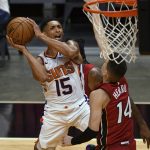 Phoenix Suns guard Cameron Payne (15) goes up for a shot as Miami Heat guard Tyler Herro (14) defends during the second half of an NBA basketball game Tuesday, March 23, 2021, in Miami. (AP Photo/Jim Rassol)