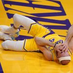 Los Angeles Lakers guard Alex Caruso lays on the floor after being hit in the face while shooting during the second half of an NBA basketball game against the Phoenix Suns Tuesday, March 2, 2021, in Los Angeles. (AP Photo/Mark J. Terrill)