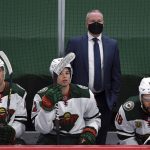 Minnesota Wild coach Dean Evason watches stands behind Nick Bonino (13), Kevin Fiala (22) and Jordan Greenway (18) during the third period of the team's NHL hockey game against the Arizona Coyotes on Tuesday, March 16, 2021, in St. Paul, Minn. The Wild won 3-0. (AP Photo/Hannah Foslien)