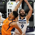 Minnesota Timberwolves guard Ricky Rubio (9) is fouled by Phoenix Suns guard Devin Booker during the first half of an NBA basketball game Friday, March 19, 2021, in Phoenix. (AP Photo/Rick Scuteri)