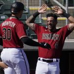 Arizona Diamondbacks' Trayce Thompson (30) celebrates his solo home run with David Peralta (6) during the second inning of a spring training baseball game against the Los Angeles Angels, Thursday, March 4, 2021, in Scottsdale, Ariz. (AP Photo/Matt York)