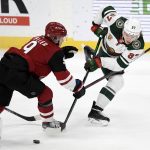 Minnesota Wild's Kirill Kaprizov (97), of Russia, passes away from Arizona Coyotes' Clayton Keller (9) during the first period of an NHL hockey game Tuesday, March 16, 2021, in St. Paul, Minn. (AP Photo/Hannah Foslien)
