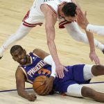 Phoenix Suns guard Chris Paul (3) slides along the floor as he looks to pass the ball while Chicago Bulls guard Tomas Satoransky defends during the first half of an NBA basketball game Wednesday, March 31, 2021, in Phoenix. (AP Photo/Ross D. Franklin)
