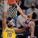 Los Angeles Lakers forward Jared Dudley, left, shoots as Phoenix Suns forward Abdel Nader defends during the second half of an NBA basketball game Tuesday, March 2, 2021, in Los Angeles. (AP Photo/Mark J. Terrill)