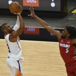 Phoenix Suns guard Chris Paul (3) shoots over Miami Heat forward Precious Achiuwa (5) during the second half of an NBA basketball game Tuesday, March 23, 2021, in Miami. (AP Photo/Jim Rassol)