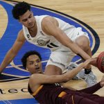 Oregon's Will Richardson, top, and Arizona State's Alonzo Verge Jr. scramble for the ball during the first half of an NCAA college basketball game in the quarterfinal round of the Pac-12 men's tournament Thursday, March 11, 2021, in Las Vegas. (AP Photo/John Locher)
