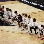 Washington State players kneel during the national anthem before an NCAA college basketball game against Arizona State in the first round of the Pac-12 men's tournament Wednesday, March 10, 2021, in Las Vegas. (AP Photo/John Locher)