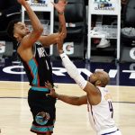 Memphis Grizzlies forward Kyle Anderson shoots over Phoenix Suns guard Jevon Carter (4) during the second half of an NBA basketball game, Monday, March 15, 2021, in Phoenix. Phoenix won 122-99. (AP Photo/Rick Scuteri)