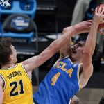 
              UCLA guard Jaime Jaquez Jr. (4) shoots over Michigan guard Franz Wagner (21) during the first half of an Elite 8 game in the NCAA men's college basketball tournament at Lucas Oil Stadium, Tuesday, March 30, 2021, in Indianapolis. (AP Photo/Michael Conroy)
            