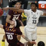 Oregon's Chandler Lawson (13) blocks a shot by Arizona State's Jaelen House (10) during the first half of an NCAA college basketball game in the quarterfinal round of the Pac-12 men's tournament Thursday, March 11, 2021, in Las Vegas. (AP Photo/John Locher)