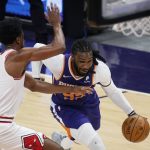 Phoenix Suns forward Jae Crowder, right, drives past Chicago Bulls forward Thaddeus Young, left, during the first half of an NBA basketball game Wednesday, March 31, 2021, in Phoenix. (AP Photo/Ross D. Franklin)