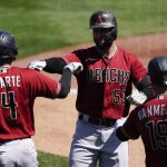 Arizona Diamondbacks' Christian Walker (53) celebrates with Ketel Marte (4) and Josh VanMeter (19) after hitting a home run during the first inning of a spring training baseball game against the Milwaukee Brewers Friday, March 19, 2021, in Phoenix. Marte and Tim Lacastro also scored. (AP Photo/Ashley Landis)