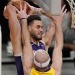Phoenix Suns forward Abdel Nader, top, tries to pass while under pressure from Los Angeles Lakers guard Alex Caruso during the first half of an NBA basketball game Tuesday, March 2, 2021, in Los Angeles. (AP Photo/Mark J. Terrill)