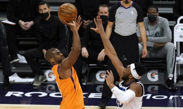 Phoenix Suns guard Chris Paul, left, shoots over Minnesota Timberwolves forward Josh Okogie during ...