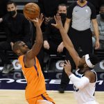 Phoenix Suns guard Chris Paul, left, shoots over Minnesota Timberwolves forward Josh Okogie during the second half of an NBA basketball game Friday, March 19, 2021, in Phoenix. Phoenix won 113-101. (AP Photo/Rick Scuteri)