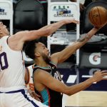Memphis Grizzlies forward Kyle Anderson shields Phoenix Suns forward Dario Saric (20) from the ball during the second half of an NBA basketball game, Monday, March 15, 2021, in Phoenix. Phoenix won 122-99. (AP Photo/Rick Scuteri)