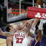 Chicago Bulls center Daniel Theis (27) and Phoenix Suns forwards Torrey Craig, right, and Dario Saric reach for a rebound during the second half of an NBA basketball game Wednesday, March 31, 2021, in Phoenix. The Suns won 121-116. (AP Photo/Ross D. Franklin)