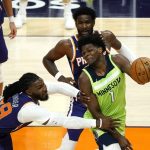 Minnesota Timberwolves forward Anthony Edwards (1) drives around Phoenix Suns forward Jae Crowder (99) and center Deandre Ayton (22) during the first half of an NBA basketball game Thursday, March 18, 2021, in Phoenix. (AP Photo/Rick Scuteri)