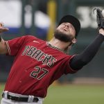 Arizona Diamondbacks' Wyatt Mathisen (27) catches a pop-up hit by Kansas City Royals Kyle Isbel for an out in the fourth inning of a spring training baseball game Thursday, March 25, 2021, in Surprise, Ariz. (AP Photo/Sue Ogrocki)