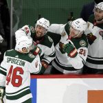 Minnesota Wild's Matt Dumba (24), Ian Cole (28) and Carson Soucy (21) congratulate Jared Spurgeon (46) on his goal against the Arizona Coyotes during the third period of an NHL hockey game Tuesday, March 16, 2021, in St. Paul, Minn. The Wild won 3-0. (AP Photo/Hannah Foslien)