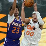 Orlando Magic forward Aaron Gordon (00) looks to pass as he is defended by Phoenix Suns forward Cameron Johnson (23) during the second half of an NBA basketball game, Wednesday, March 24, 2021, in Orlando, Fla. (AP Photo/John Raoux)