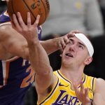 Los Angeles Lakers guard Alex Caruso, right, is hit in the face by Phoenix Suns forward Dario Saric as he shoots during the second half of an NBA basketball game Tuesday, March 2, 2021, in Los Angeles. (AP Photo/Mark J. Terrill)