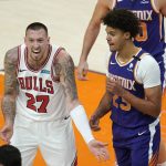 Chicago Bulls center Daniel Theis (27) argues with an official as Phoenix Suns forward Cameron Johnson, right, pauses nearby during the second half of an NBA basketball game Wednesday, March 31, 2021, in Phoenix. The Suns won 121-116. (AP Photo/Ross D. Franklin)