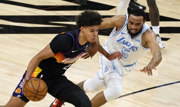 Phoenix Suns forward Cameron Johnson drives on Los Angeles Lakers guard Talen Horton-Tucker (5) dur...