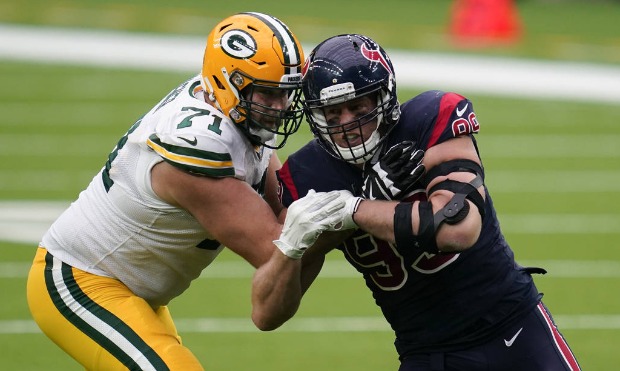 In this Sunday Oct. 25, 2020 file photo, Houston Texans defensive end J.J. Watt, right, rushes up f...