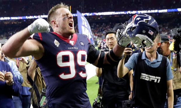Houston Texans defensive end J.J. Watt (99) celebrates with fans after an NFL wild-card playoff foo...