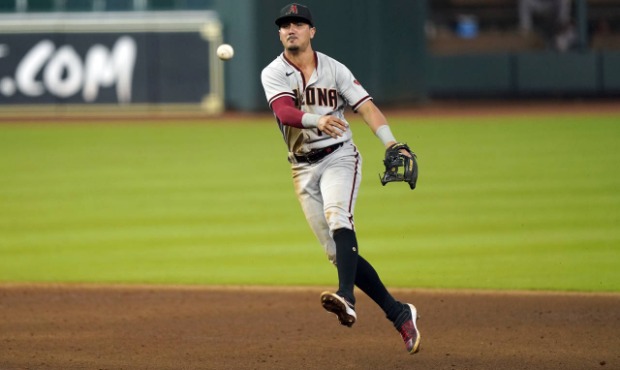 Arizona Diamondbacks second baseman Josh Rojas throws to first for the out after fielding a ground ...