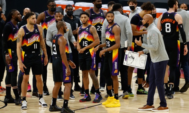 Head coach Monty Williams (R) of the Phoenix Suns talks with Jae Crowder #99, Abdel Nader #11, Chri...
