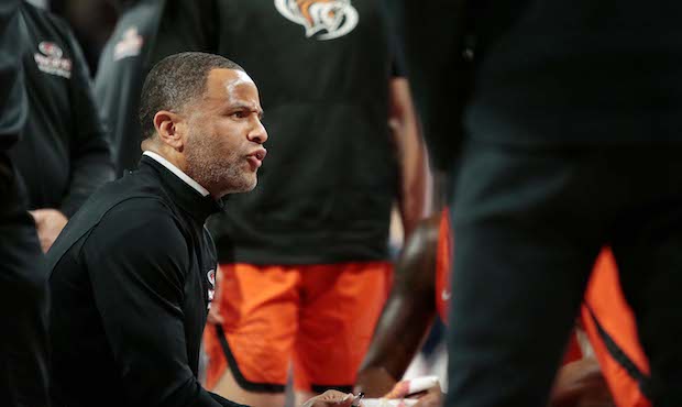 Head coach Damon Stoudamire of the Pacific Tigers huddles with his players during a timeout in the ...