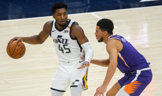 Devin Booker #1 of the Phoenix Suns guards Donovan Mitchell #45 of the Utah Jazz during a game at V...