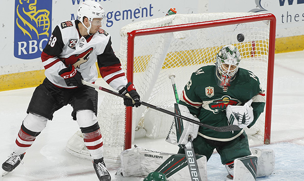 Cam Talbot #33 of the Minnesota Wild makes a save against Michael Bunting #58 of the Arizona Coyote...