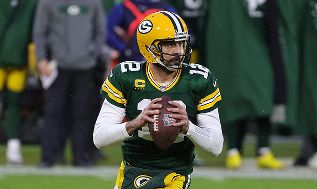 Aaron Rodgers #12 of the Green Bay Packers looks to pass against the Los Angeles Rams during the NF...