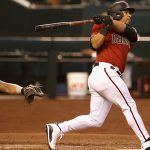 PHOENIX, ARIZONA - APRIL 11: Eduardo Escobar #5 of the Arizona Diamondbacks hits a two-run home run against the Cincinnati Reds during the fifth inning of the MLB game at Chase Field on April 11, 2021 in Phoenix, Arizona. (Photo by Christian Petersen/Getty Images)