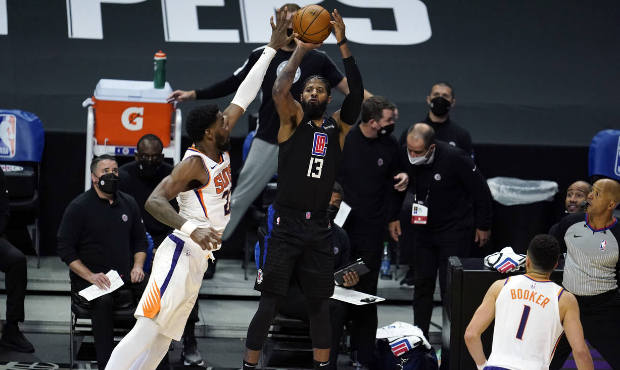 Los Angeles Clippers guard Paul George (13) makes a 3-point basket over Phoenix Suns center Deandre...
