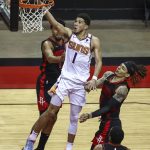 Phoenix Suns guard Devin Booker (1) shoots against Houston Rockets forward D.J. Wilson (00) during the third quarter of an NBA basketball game in Houston, Monday, April 5, 2021. (Troy Taormina/Pool Photo via AP)