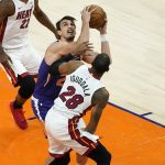 Phoenix Suns forward Dario Saric shoots as Miami Heat forward Andre Iguodala (28) defends during the first half of an NBA basketball game, Tuesday, April 13, 2021, in Phoenix. (AP Photo/Matt York)