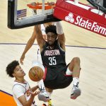 
              Houston Rockets center Christian Wood (35) dunks over Phoenix Suns forward Cameron Johnson during the first half of an NBA basketball game, Monday, April 12, 2021, in Phoenix. (AP Photo/Matt York)
            
