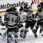 Arizona Coyotes left wing Lawson Crouse and Los Angeles Kings left wing Matt Roy tussle in front of the Kings' net during the second period of an NHL hockey game, Saturday, April 24, 2021, in Los Angeles. (AP Photo/Michael Owen Baker)