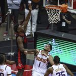 Houston Rockets forward Jae'Sean Tate (8) shoots against Phoenix Suns guard Devin Booker (1) during the third quarter of an NBA basketball game in Houston, Monday, April 5, 2021. (Troy Taormina/Pool Photo via AP)