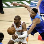 Milwaukee Bucks' Giannis Antetokounmpo, right, hits the ball away from Phoenix Suns' Chris Paul, left, during the second half of an NBA basketball game Monday, April 19, 2021, in Milwaukee. (AP Photo/Aaron Gash)