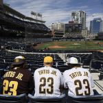 Baseball fans sit in the stands before a baseball game between the Arizona Diamondbacks and the San Diego Padres Thursday, April 1, 2021, on opening day in San Diego. (AP Photo/Denis Poroy)