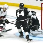 Arizona Coyotes left wing Michael Bunting, left, scores his second goal of the game as Los Angeles Kings defenseman Mikey Anderson, center and goaltender Calvin Petersen defend during the first period of an NHL hockey game Monday, April 5, 2021, in Los Angeles. (AP Photo/Mark J. Terrill)