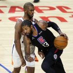 Los Angeles Clippers guard Paul George (13) is defended by Phoenix Suns guard Chris Paul during the second half of an NBA basketball game Thursday, April 8, 2021, in Los Angeles. (AP Photo/Marcio Jose Sanchez)