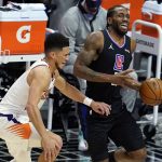 Los Angeles Clippers forward Kawhi Leonard, right, is defended by Phoenix Suns guard Devin Booker during the first half of an NBA basketball game Thursday, April 8, 2021, in Los Angeles. (AP Photo/Marcio Jose Sanchez)